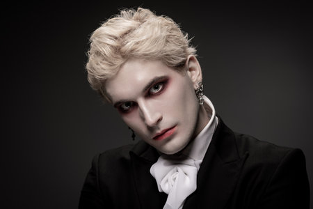 A young man showcases a striking Halloween costume with impressive makeup and style.の写真素材