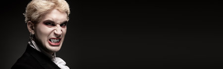 A confident young man in a creative Halloween costume showcases a fierce expression.の写真素材