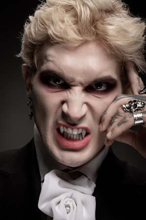 A young man displays an impressive Halloween costume while striking a fierce, captivating pose.