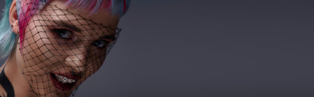 A young woman showcases her colorful, short hair while enjoying a moment in a studio settingYoung woman with colorful hair and striking beauty in a modern studio settingのeditorial素材