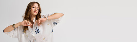 Beautiful young woman dressed in stylish attire poses expressively with confidence and flair.