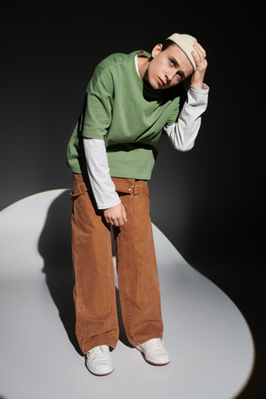 Stylish teen flaunts trendy outfit and relaxed vibe in a studio.