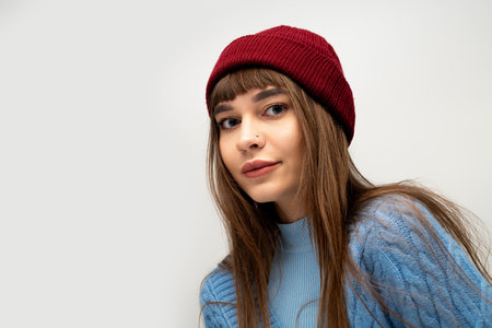 A young woman poses joyfully in cozy autumn attire, capturing the essence of warmth and style.の写真素材