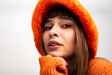 A beautiful young woman poses in warm attire, exuding confidence and style during autumn.