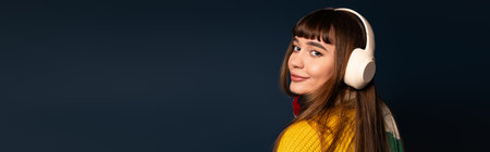 Young woman in cozy attire poses actively, showcasing her lively spirit during autumn.