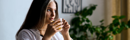 A woman with Waardenburg syndrome sips tea at home, bannerの写真素材