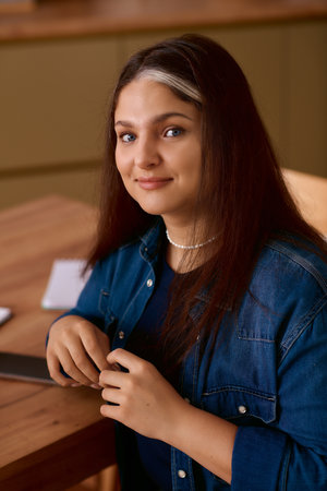 A woman with Waardenburg syndrome highlighting her unique white forelock.の写真素材