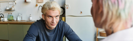 A happy couple enjoys their time together, radiating love and warmth in a charming kitchen.の写真素材