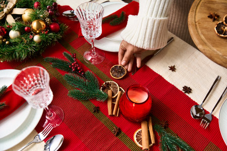 Celebrate Christmas with festive decorations and tasty treats on the table.の写真素材