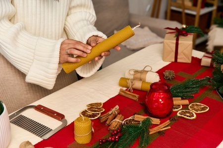 Crafting holiday decor with candles, dried fruits, and fragrant spices for a joyful celebration.の写真素材