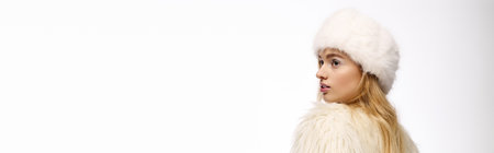 Young woman with blonde hair showcases winter makeup in a stylish outfit, bannerの写真素材