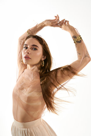 A young woman captivates with her elegance and flowing hair against a soft backdrop.の写真素材