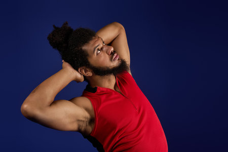 African American man expresses determination through fitness activity with athletic form and focus.の写真素材