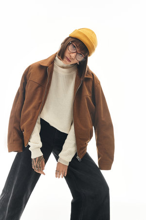 Young woman stands confidently in trendy attire, blending comfort with chic fashion elements.
