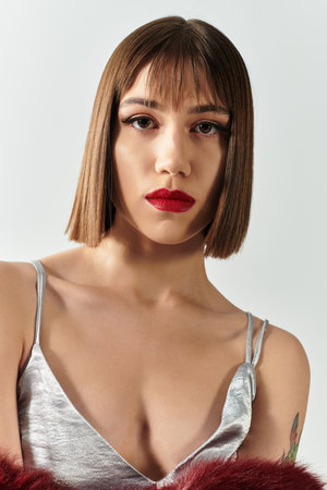 Young woman exudes elegance in a fashionable outfit, expressing her unique style and charm.の写真素材