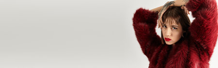 A beautiful young woman poses in fashionable attire, showcasing her modern style and allure.の写真素材