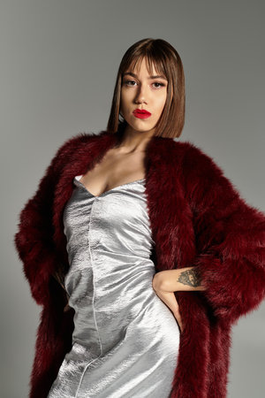 In a chic outfit, a young woman radiates beauty and poise, capturing a stunning moment.の写真素材