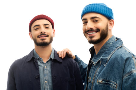 Two brothers in matching stylish attire smile confidently, celebrating their bond.の写真素材