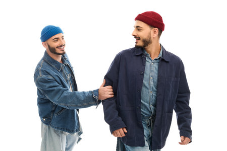 Two brothers share a lighthearted moment, dressed in trendy outfits, showcasing their bond.の写真素材