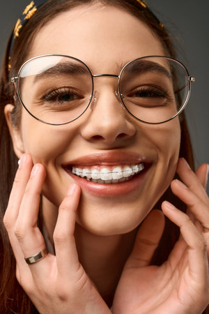 Young woman in college uniform radiates happiness while posing in a well-lit studio.