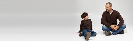 A loving father enjoys quality time with his young son, sharing smiles and laughter together.の写真素材