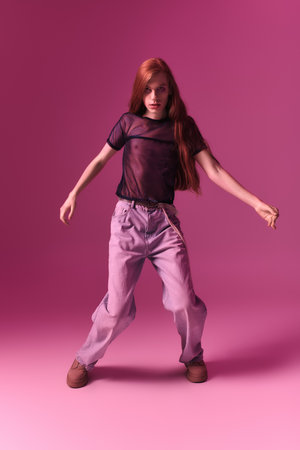 A person joyfully dances on a bright pink background, showing their true colors.の写真素材