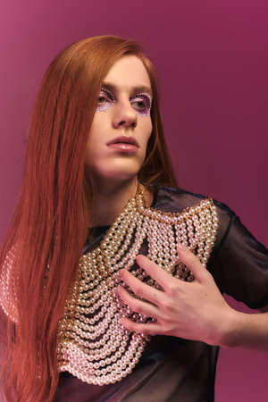 A person showcases their individuality with striking makeup, pearls, and a bold stance.の写真素材