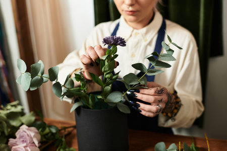 A young woman arranges vivid flowers in her charming flower shop.
