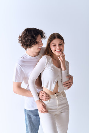 Happy couple shares a tender moment together, radiating love and warmth in a stylish studio.