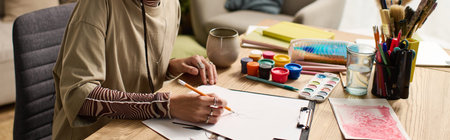 A young woman expresses creativity through art at home, banner
