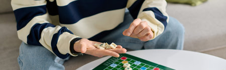 Focused young man skillfully plays a board game, showcasing his thoughtful demeanor at home.