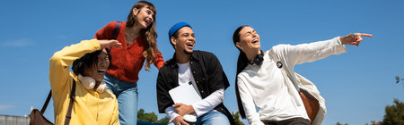 Four friends share laughter and joy outdoors, enjoying nature together.