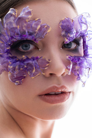 A stunning young woman captivates with her unique floral mask, radiating elegance and charm.
