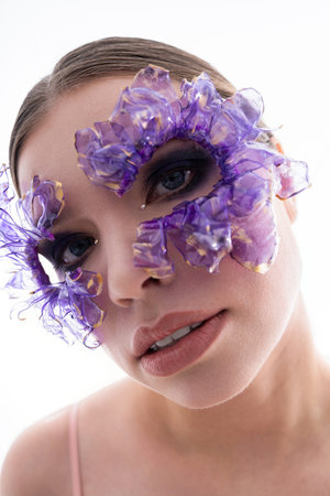 A radiant young woman displays unique purple accessories that elegantly accent her features.