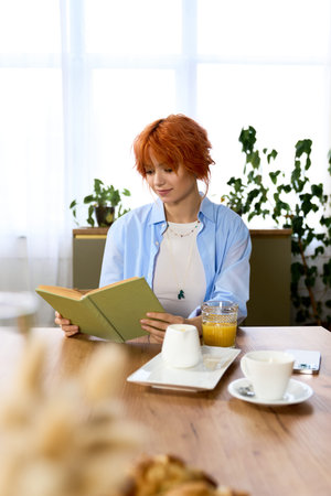 Bright and cozy setting where a young woman with red hair reads joyfully while savoring breakfast.