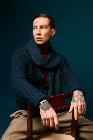 Handsome man poses confidently in a chic outfit, exuding style and charisma in a vibrant studio.