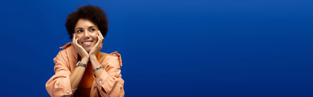 A young beautiful woman enjoys a moment of joy, dressed elegantly in a fashionable attire.の写真素材