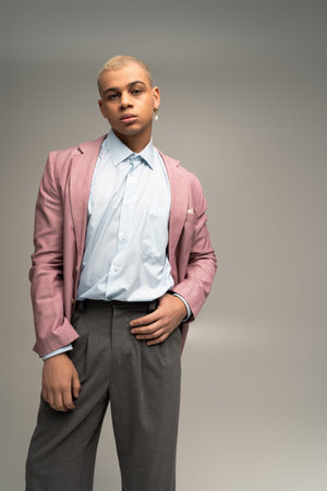 A dapper gentleman poses confidently in a stylish blend of classic and modern attire.