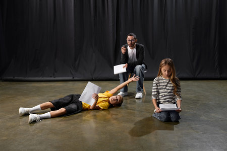 Stylish male educator guides eager kids through fun theater activities, sparking their creativity.