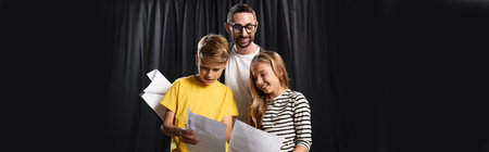 Stylish male tutor guides enthusiastic kids as they explore acting and performance in theater.