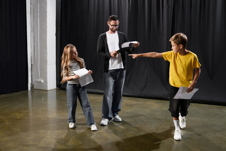 Excited children learn theater skills with a stylish tutor, enhancing creativity and confidence.の写真素材