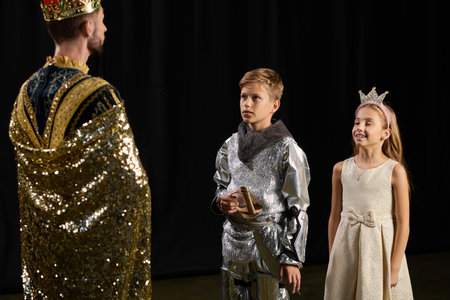 A creative male tutor inspires joy and imagination in children during theater class.