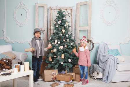 Photo children around the Christmas treeの写真素材