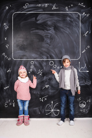 Thoughts of children against the black chalkboardsの写真素材