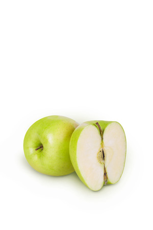 Green apple and half apple beside him on white backgroundの写真素材