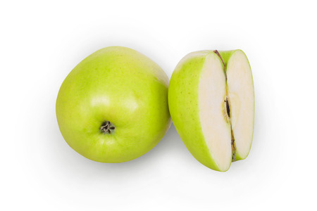 Green apple and half apple beside him on white backgroundの写真素材