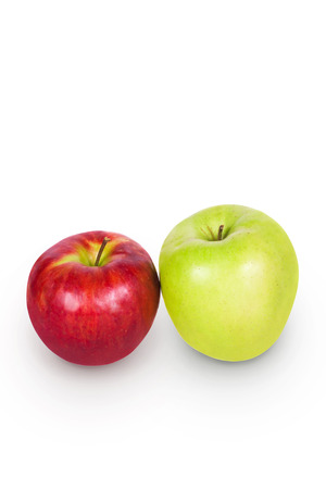 Green and white apples side by side on a white backgroundの写真素材
