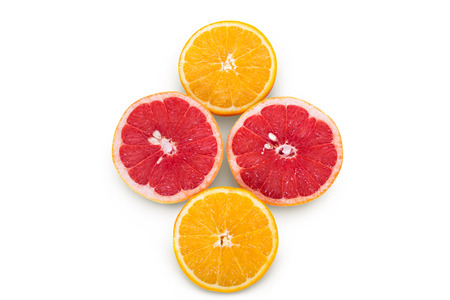 The two halves of orange and grapefruit on a white backgroundの写真素材