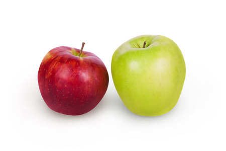 Green and white apples side by side on a white backgroundの写真素材