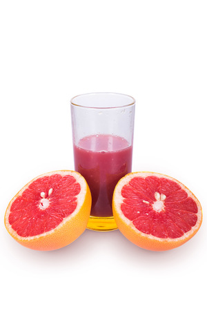 Juicy and ripe grapefruit near Frechet cup on a white backgroundの写真素材
